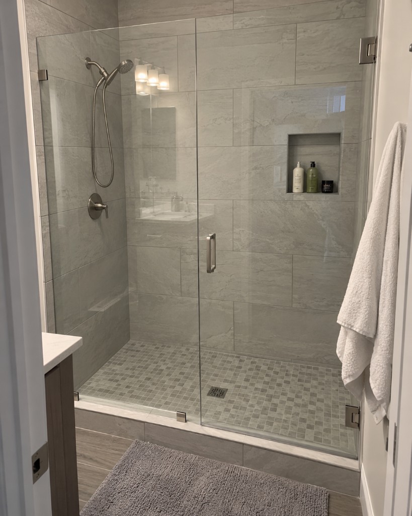 Glass shower with marble tile